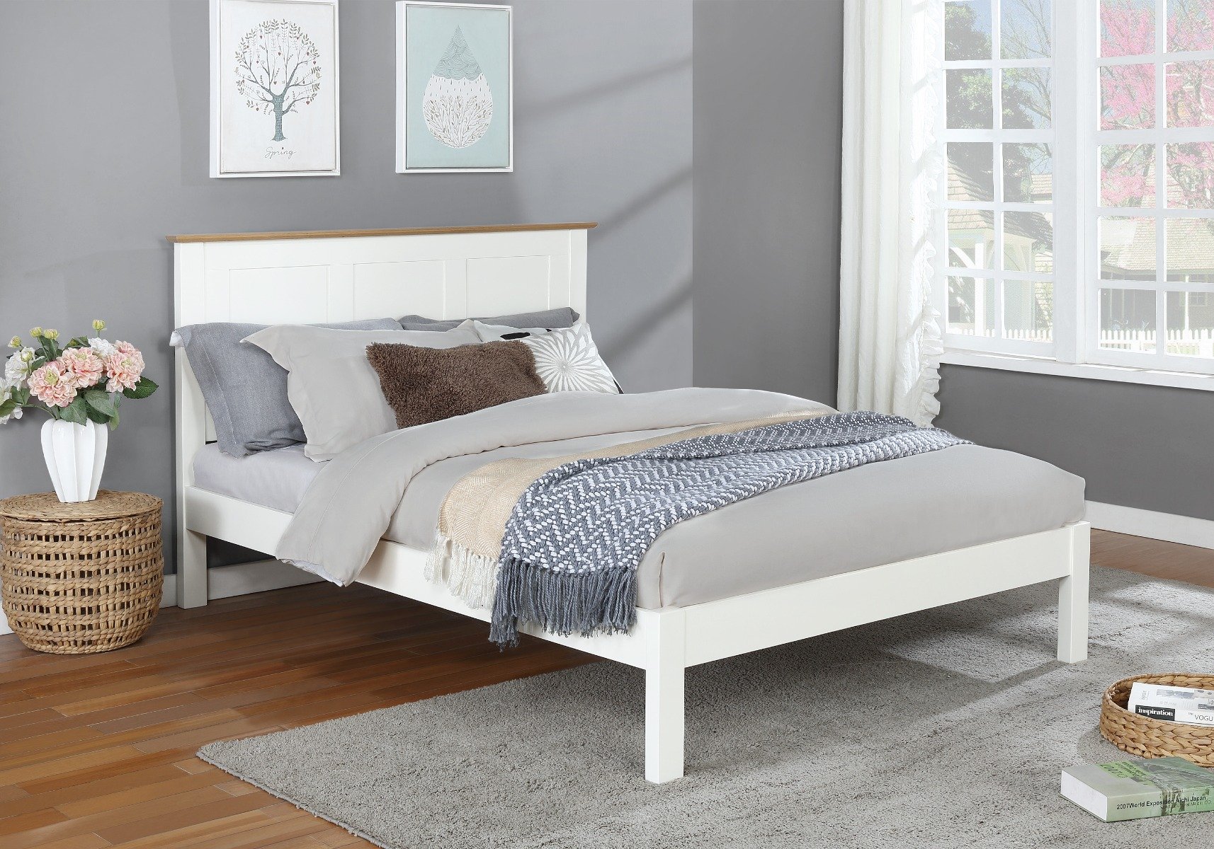 White wooden double bed with grey, yellow, and blue bedsheets