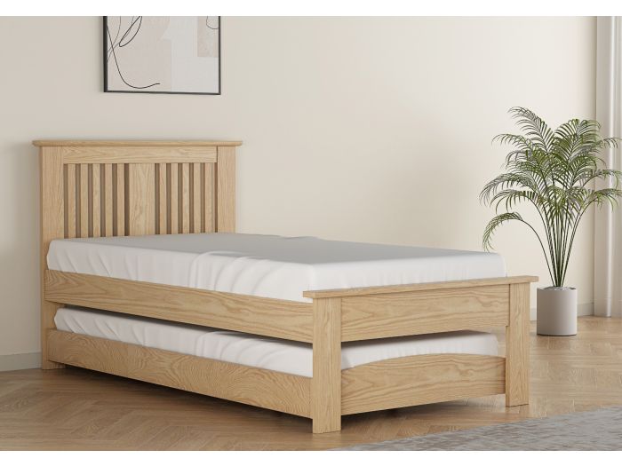 Contemporary oak finish guest bed with pull out under bed. Slatted headboard with a plinth top. Low foot end with a plinth top.