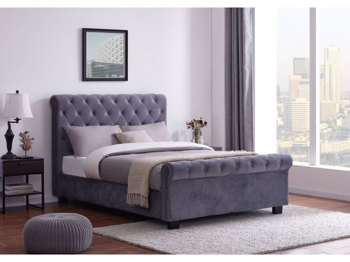 An elegant Chesterfield style ottoman bed frame upholstered in a plush grey fabric.