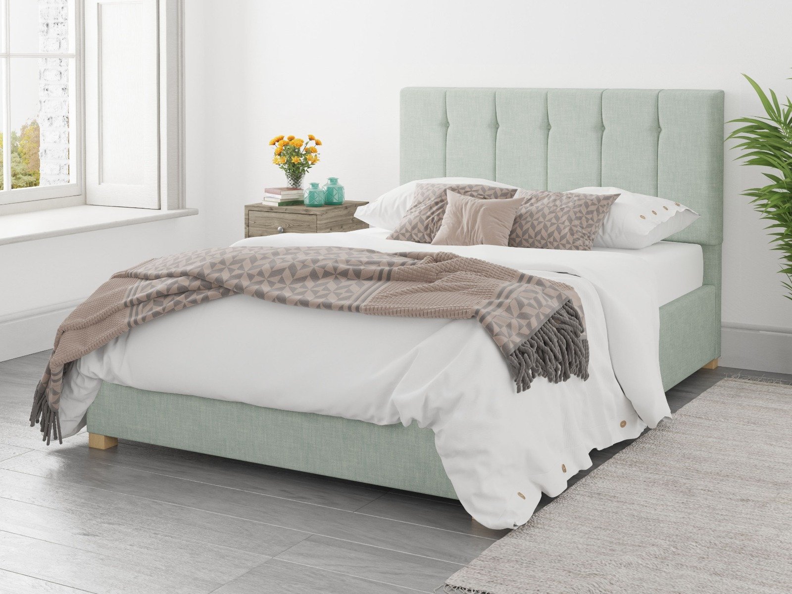 Green ottoman bed with white and brown bedsheets