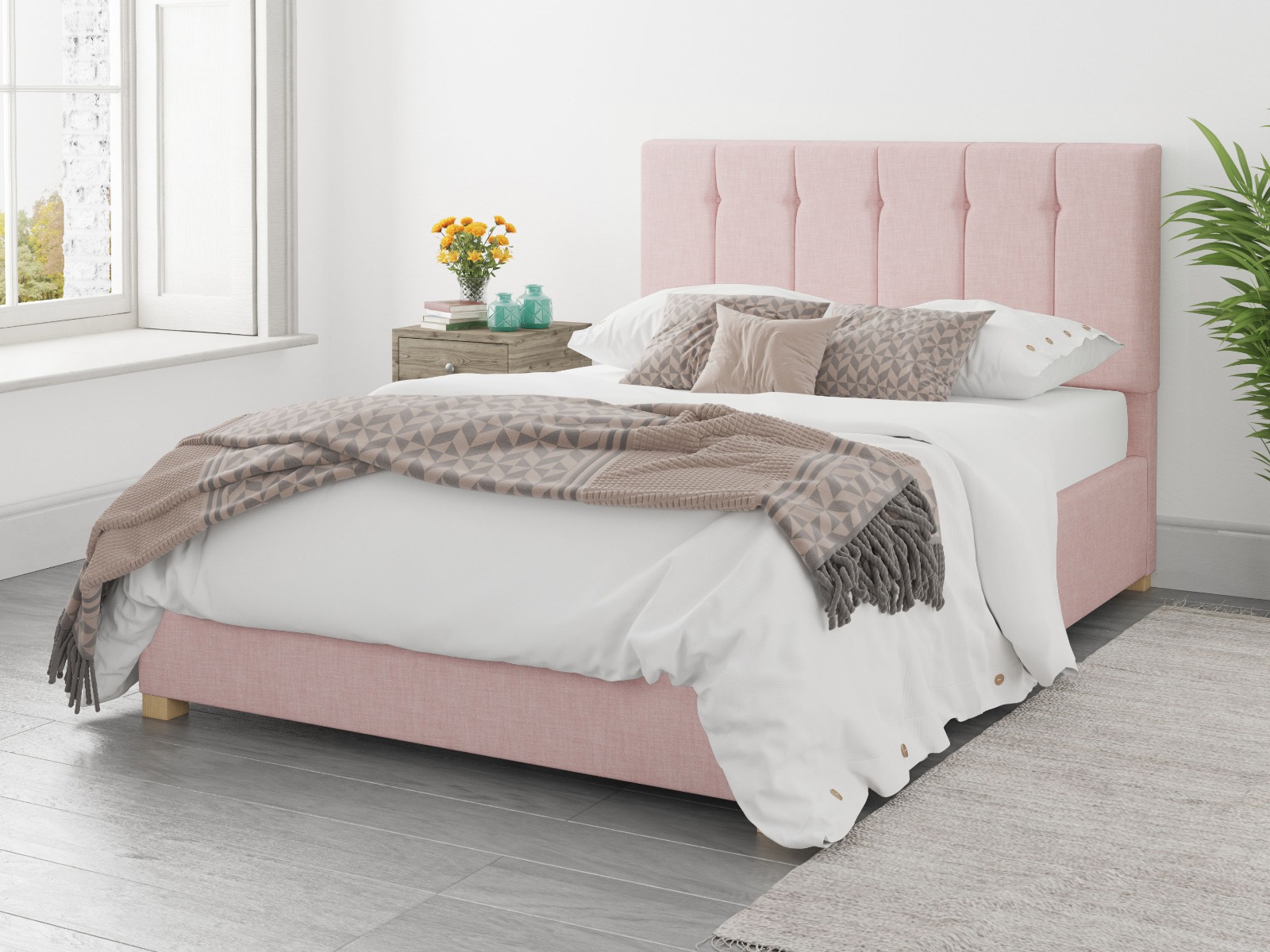 Pink ottoman bed with brown and white bedsheets